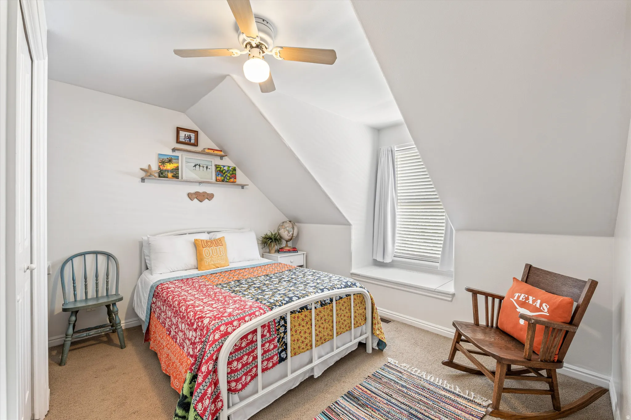 Bedroom with vaulted ceiling, light carpet, and ceiling fan