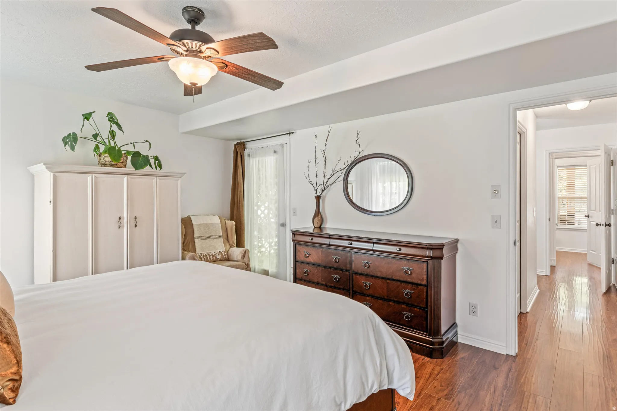 Bedroom featuring dark wood-style floors and ceiling fan