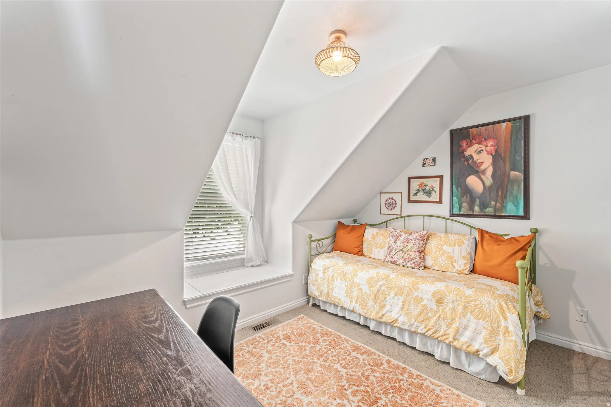 Bedroom featuring vaulted ceiling and carpet