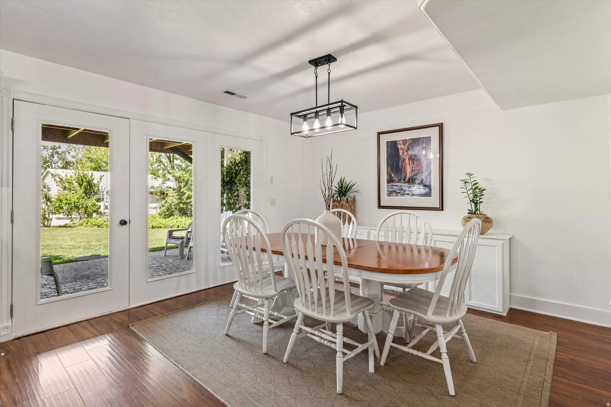 Dining area featuring dark wood-type flooring and french doors
