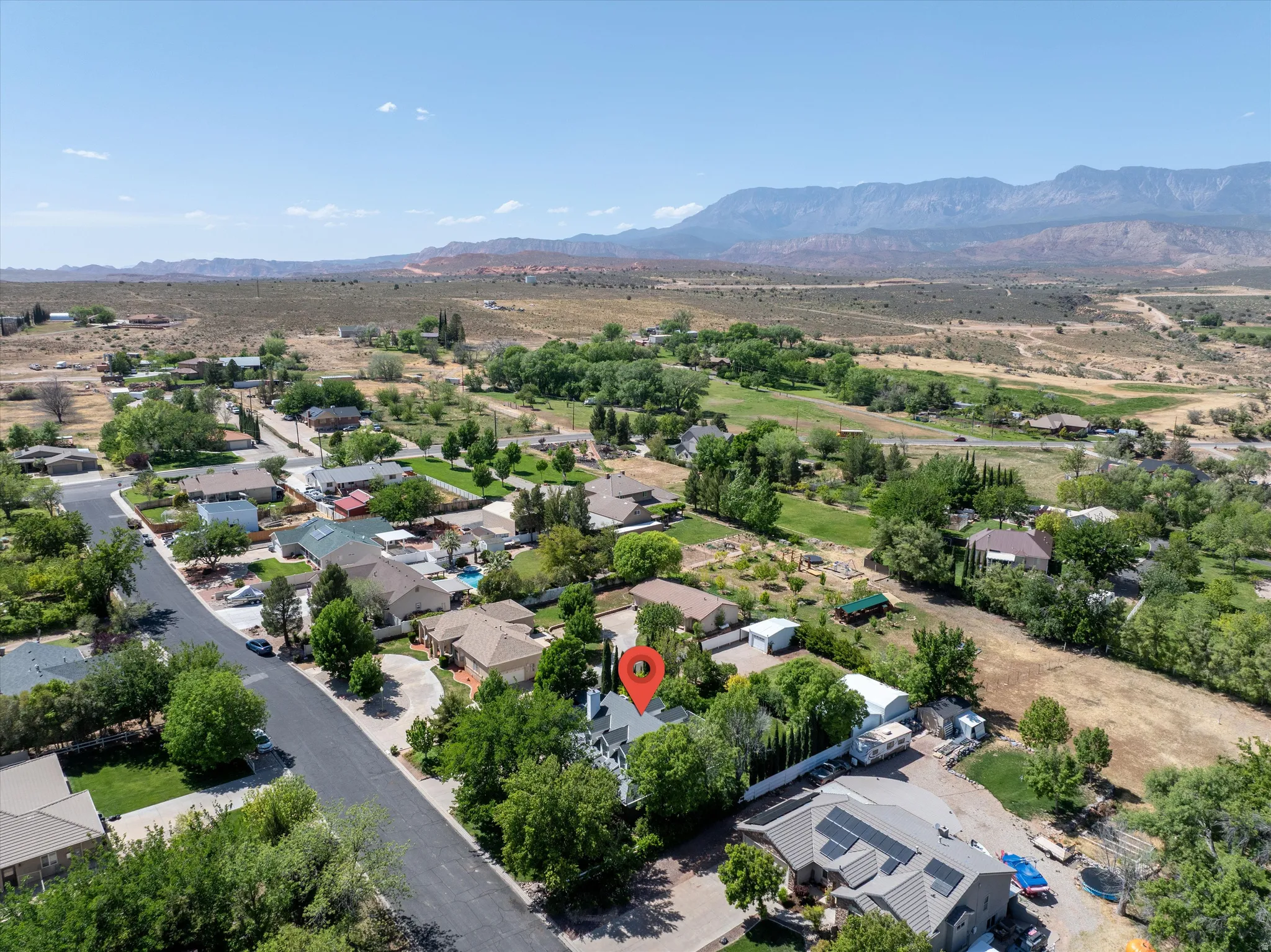 Aerial perspective of suburban area with a mountain backdrop