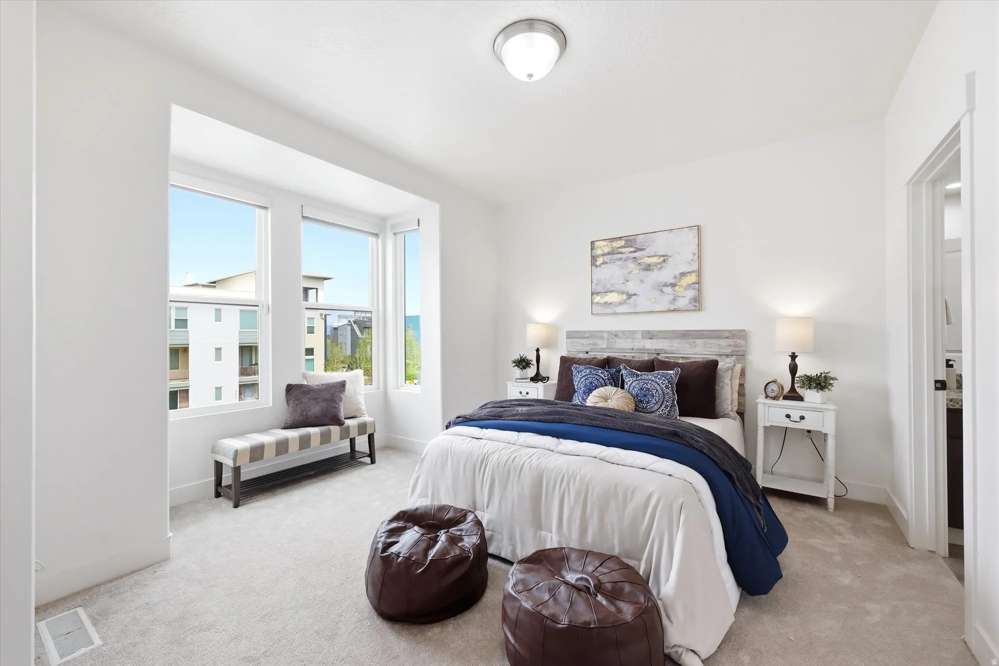 Bedroom with baseboards and light colored carpet