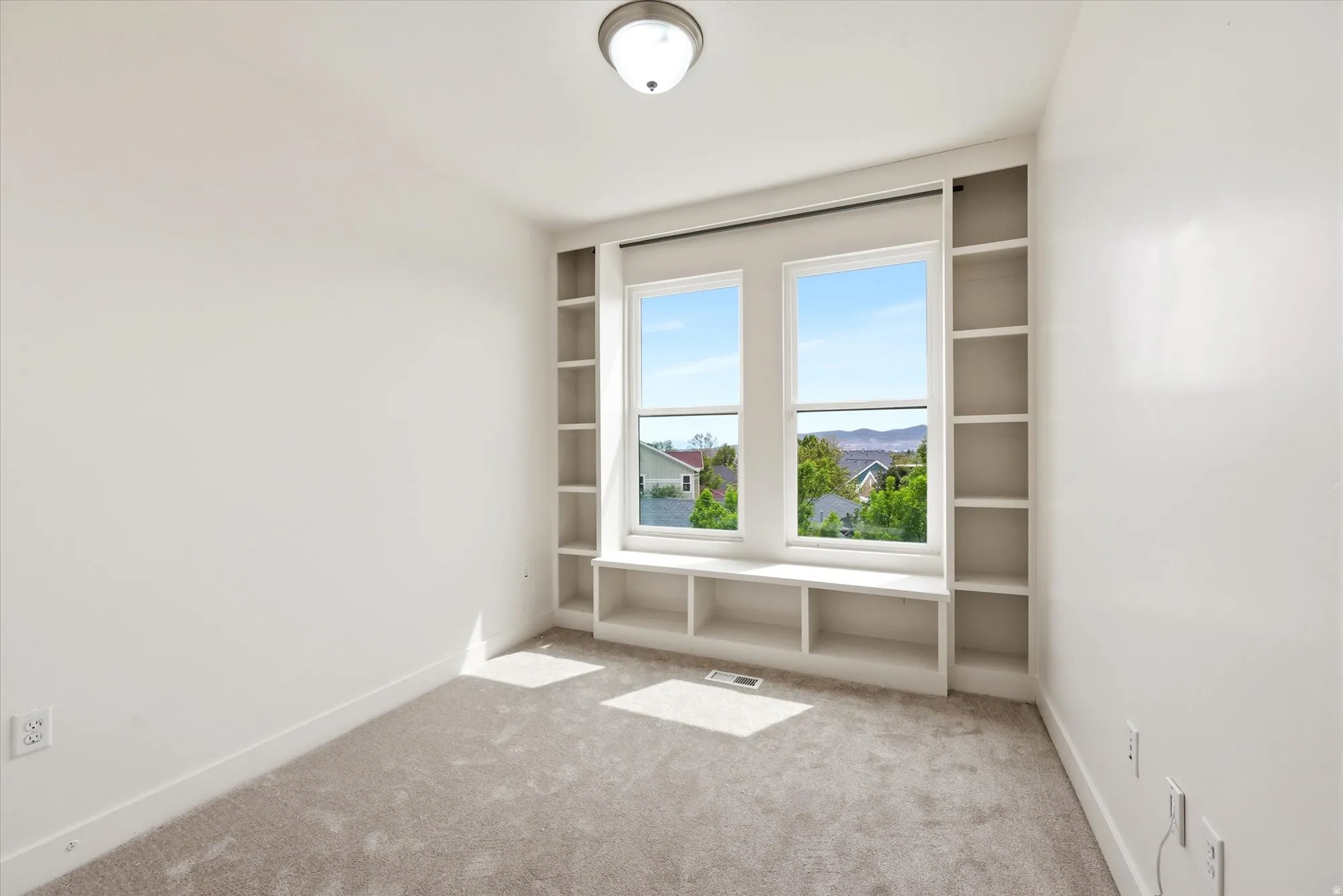 Empty room with light carpet and a mountain view