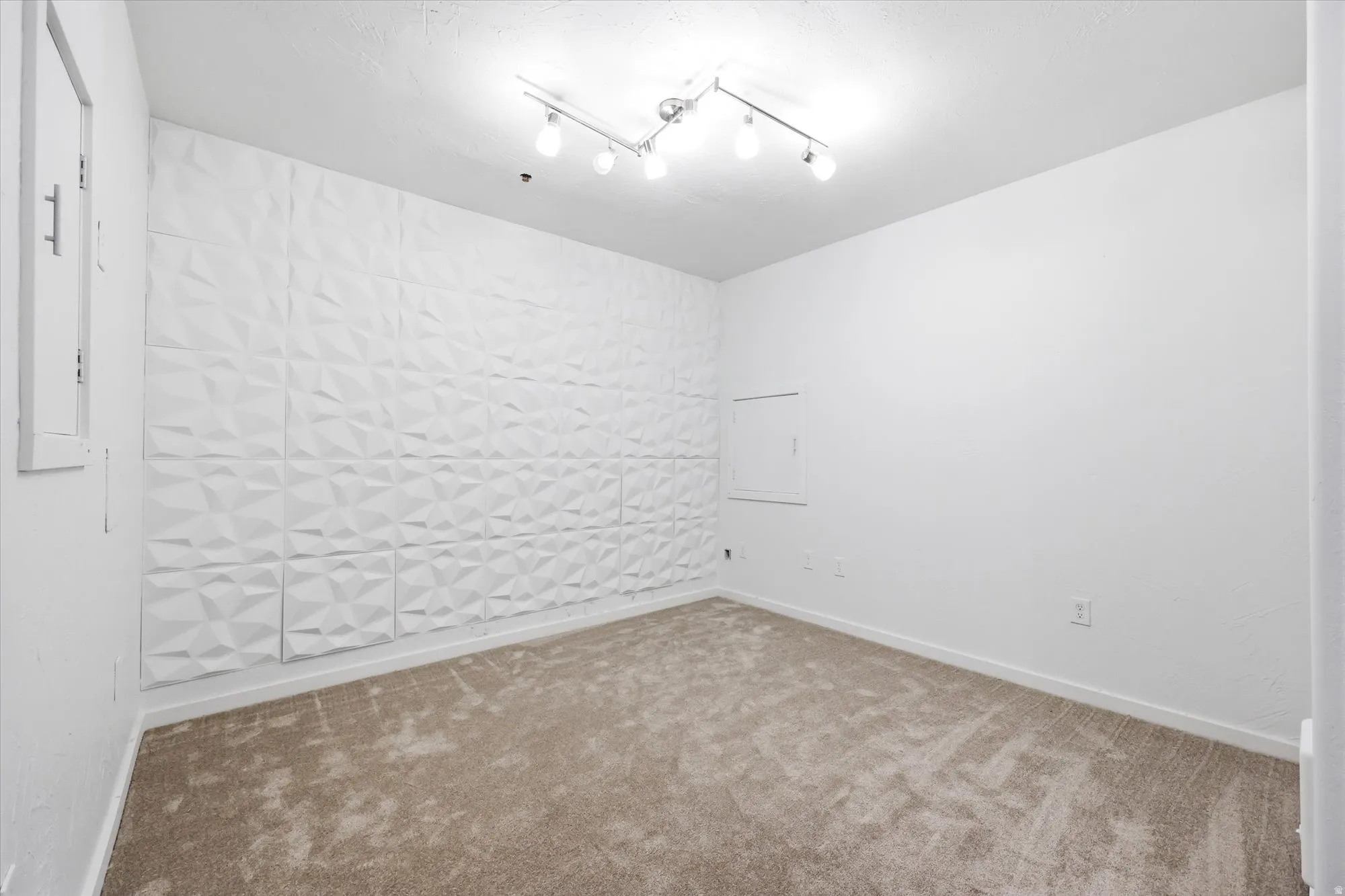 Basement bonus room featuring carpet flooring and baseboards