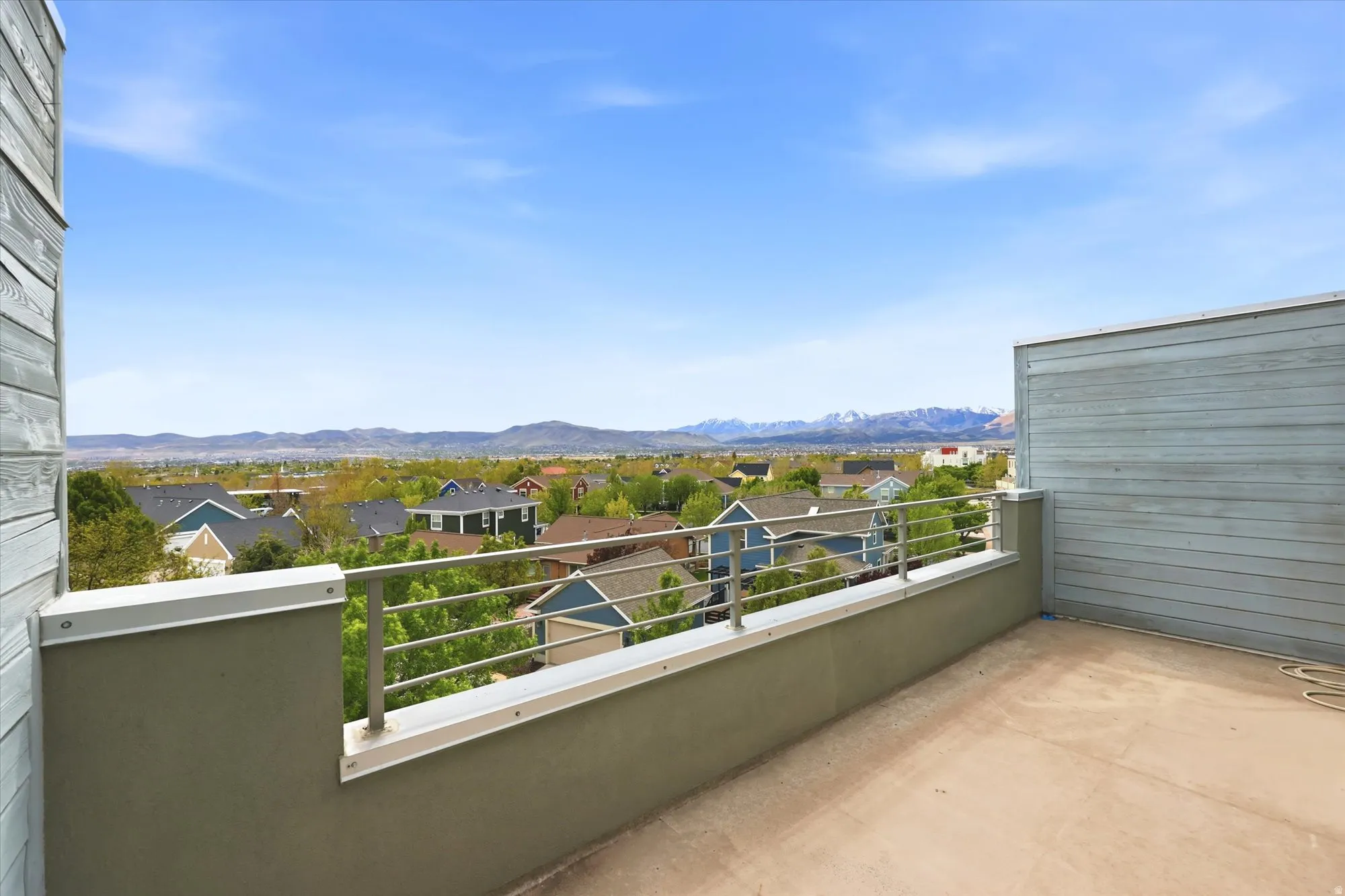 Balcony featuring a residential view and a mountain view