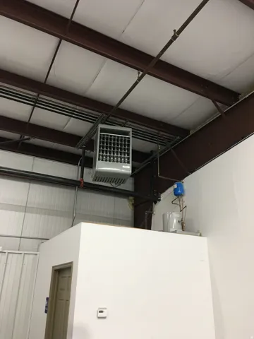 Garage view of a heating unit and metal wall