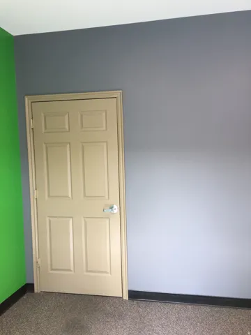 Spare room featuring baseboards and carpet flooring