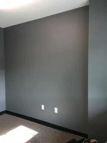 Empty room featuring baseboards and light carpet
