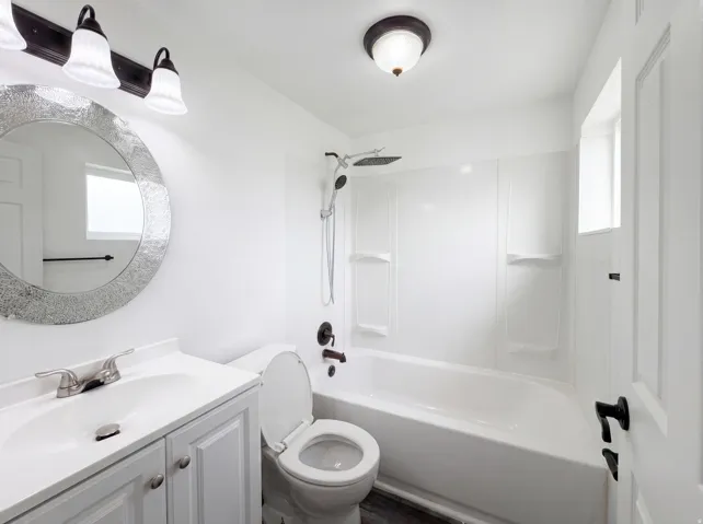 Bathroom with vanity and shower / washtub combination