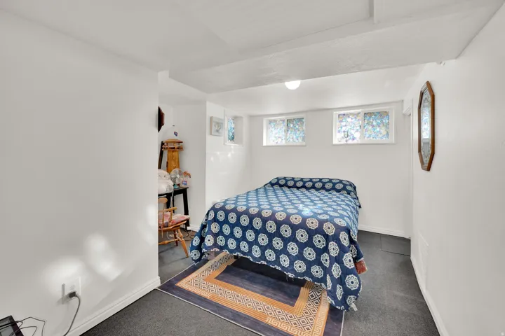 Bedroom featuring dark carpet and baseboards