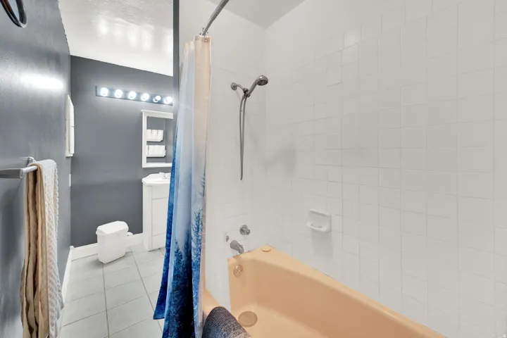 Full bathroom featuring light tile patterned flooring, shower / bath combo, and vanity