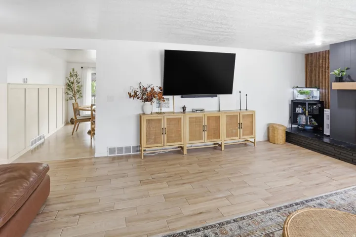 Living room featuring wood finish floors and a textured ceiling