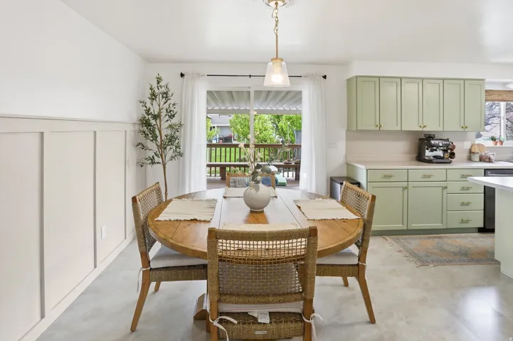 Dining room with a decorative wall and a wainscoted wall