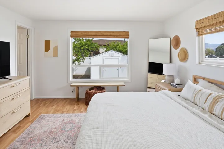 Bedroom with light wood-style flooring and baseboards