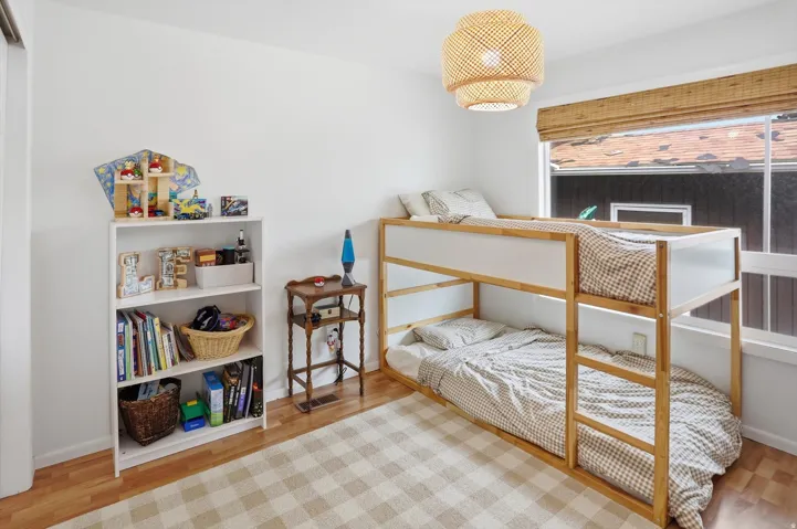 Bedroom featuring light wood-style flooring and baseboards