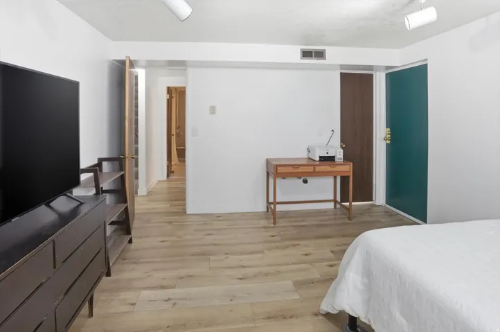 Bedroom with light wood-type flooring and a textured ceiling