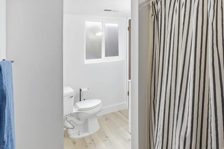 Bathroom featuring a shower with curtain and light wood finished floors