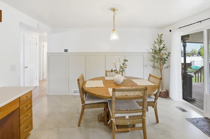 Dining room with a decorative wall and a wainscoted wall