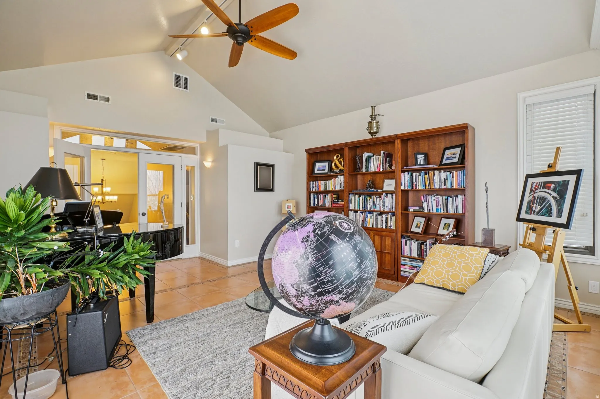 Living room featuring light tile patterned floors and a ceiling fan