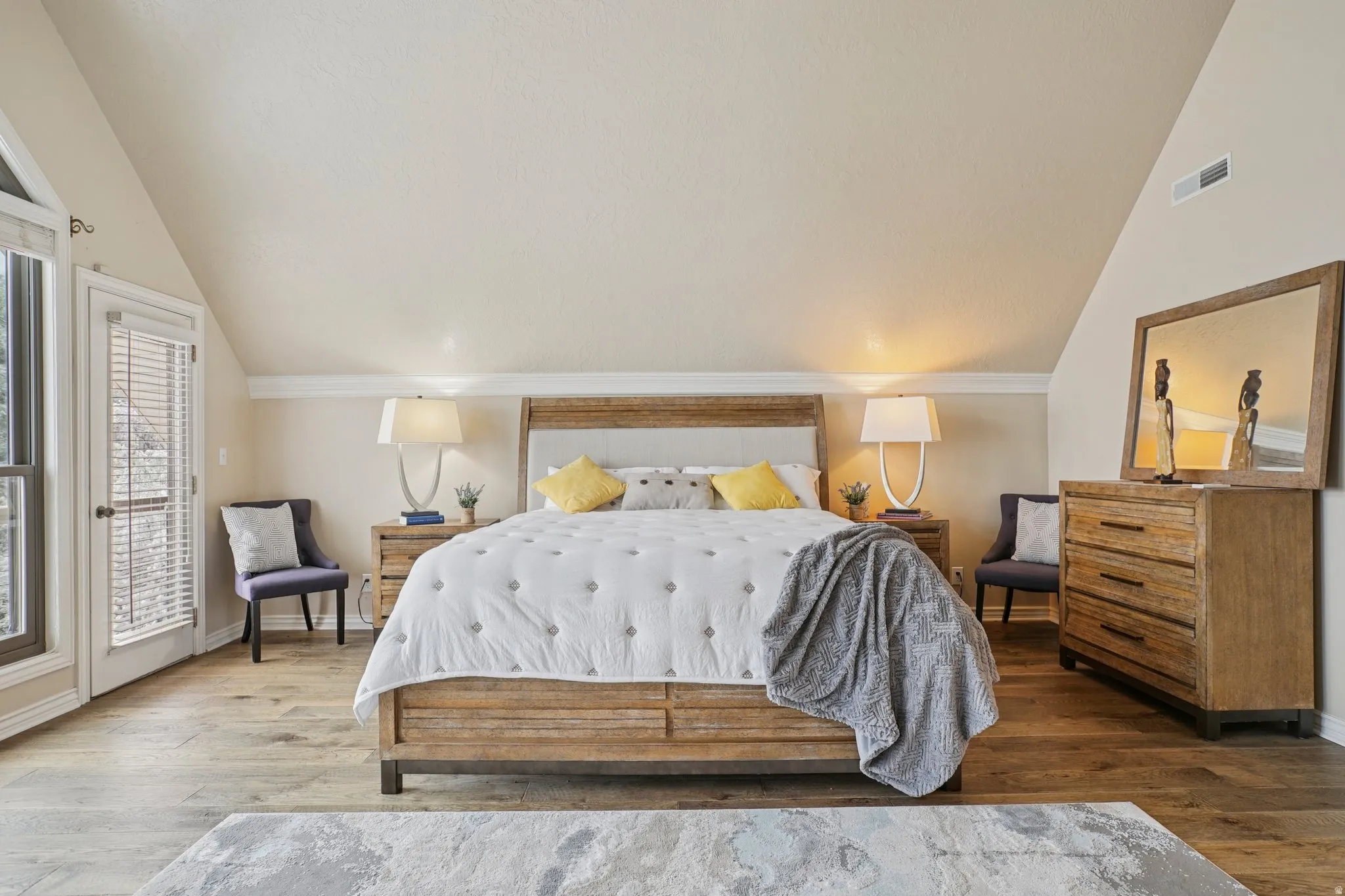 Bedroom with lofted ceiling, wood-type flooring, and access to outside
