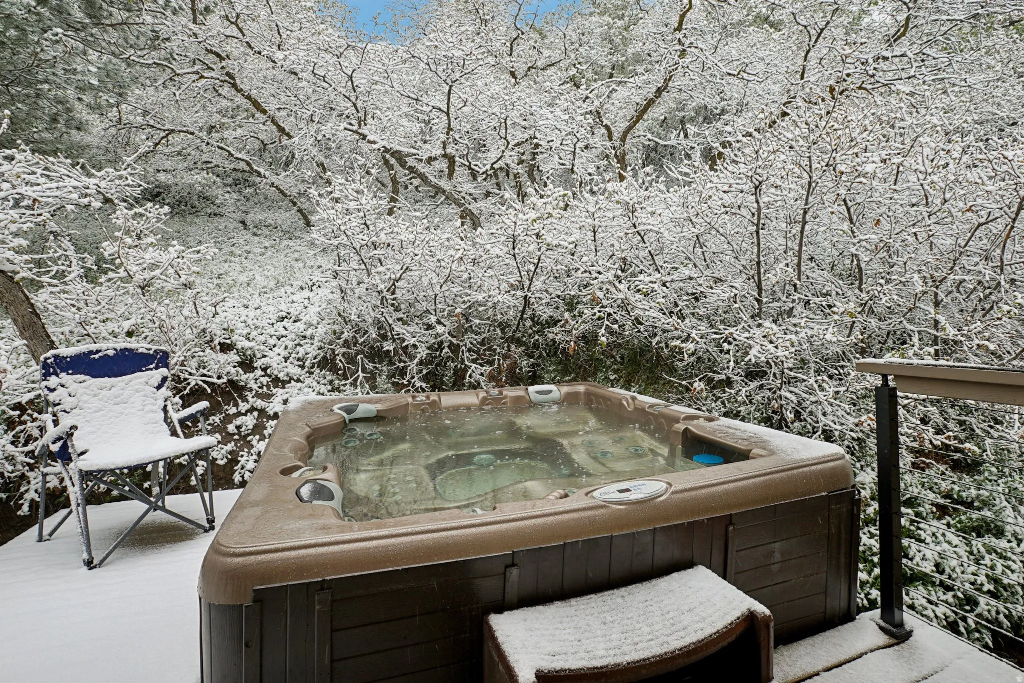 Wooden terrace featuring a hot tub