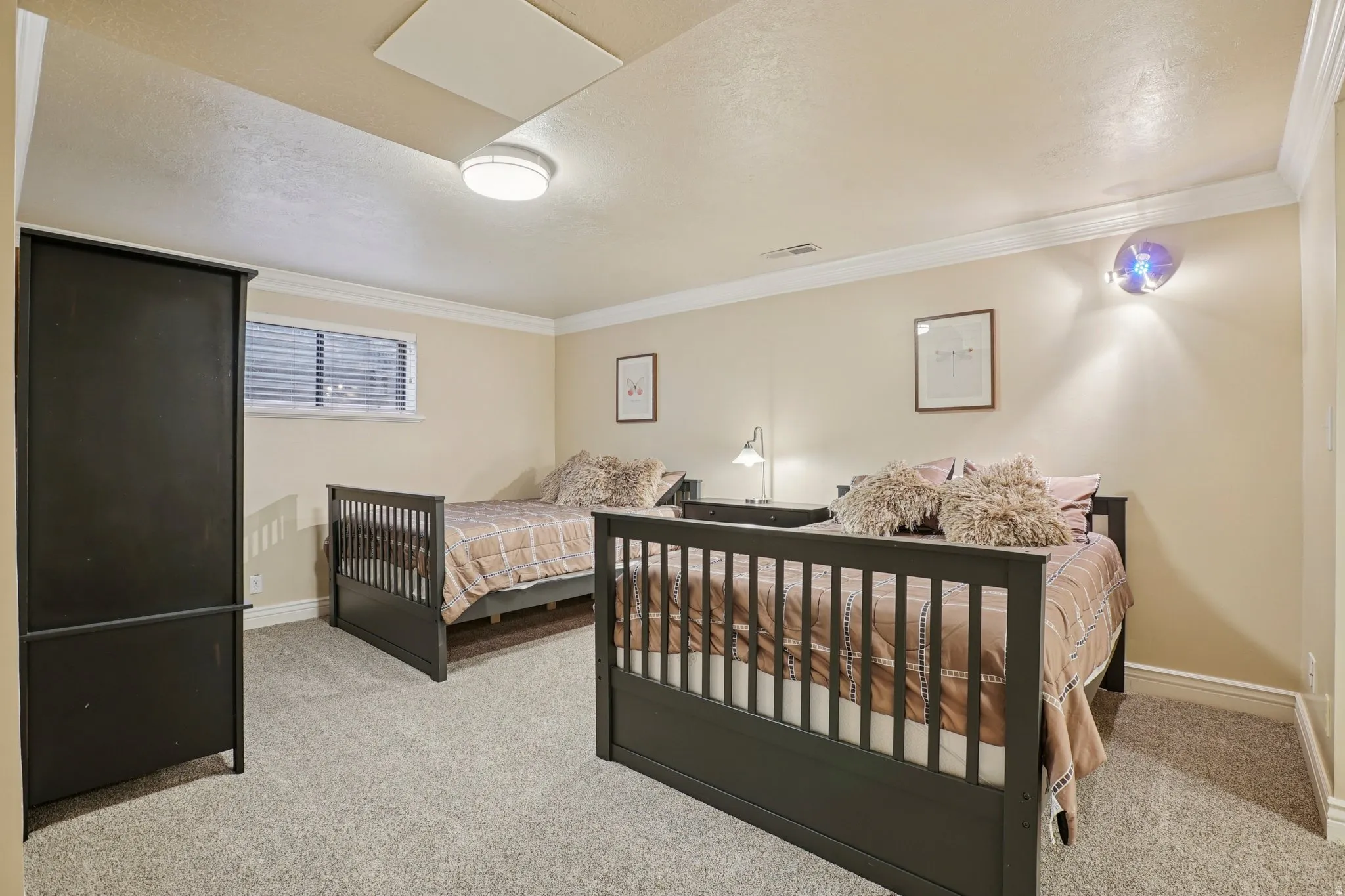 Bedroom featuring light colored carpet and ornamental molding