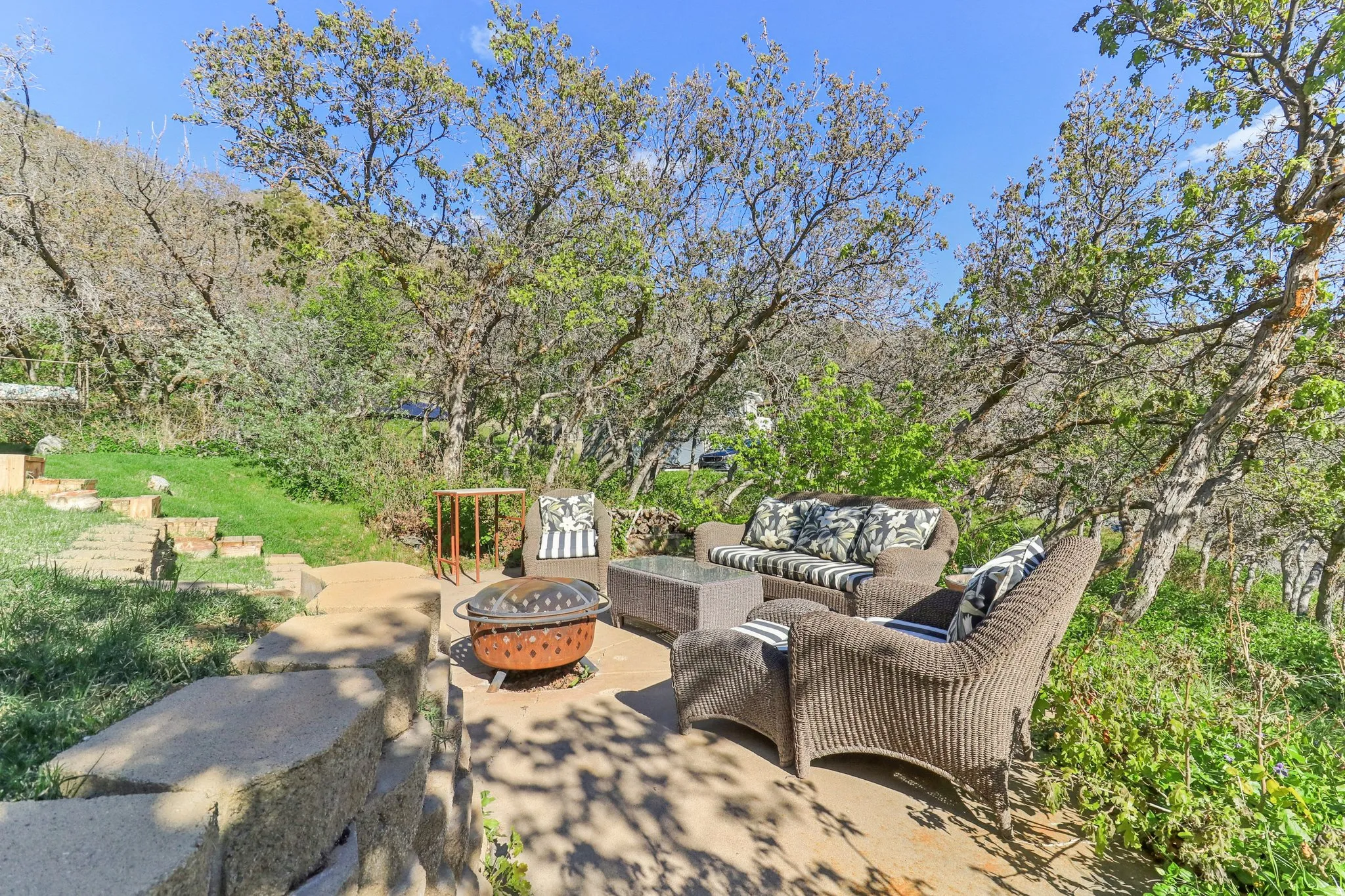 View of patio with an outdoor fire pit