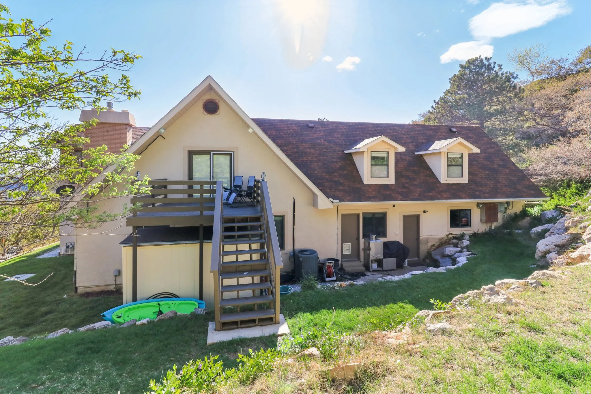 Rear view of property featuring a patio area, stucco siding, a yard, and a deck