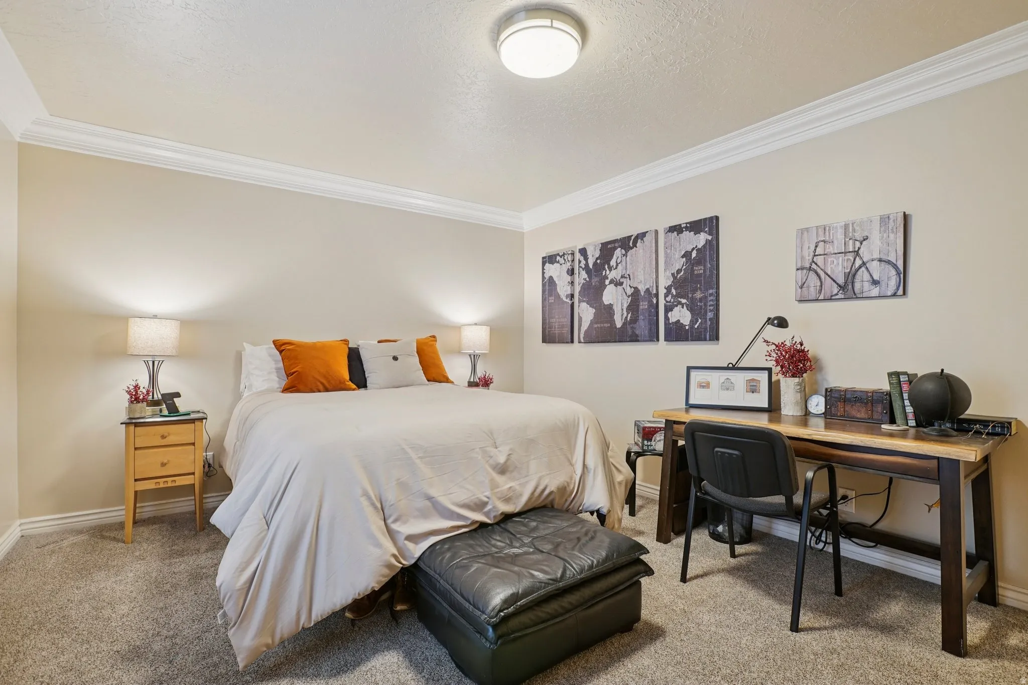 Bedroom with light carpet, ornamental molding, and an office area
