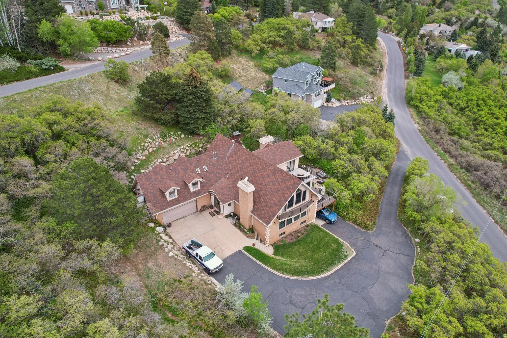 View from above of property with a tree filled landscape