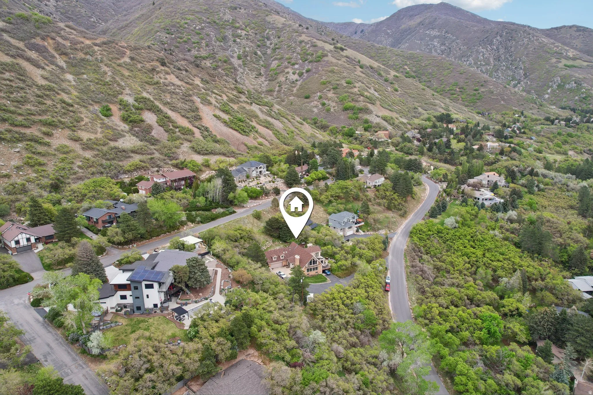 Aerial perspective of suburban area featuring a mountain backdrop