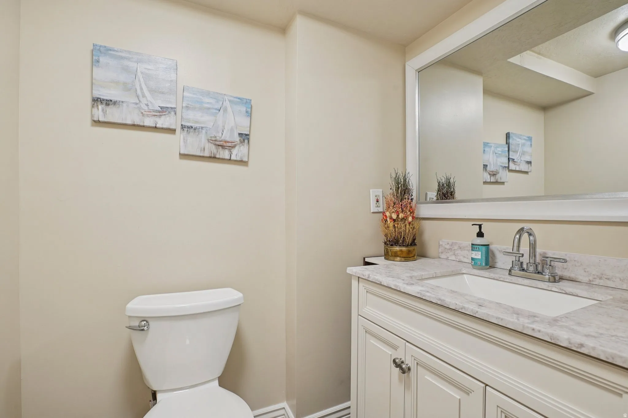 Half bathroom featuring vanity and toilet