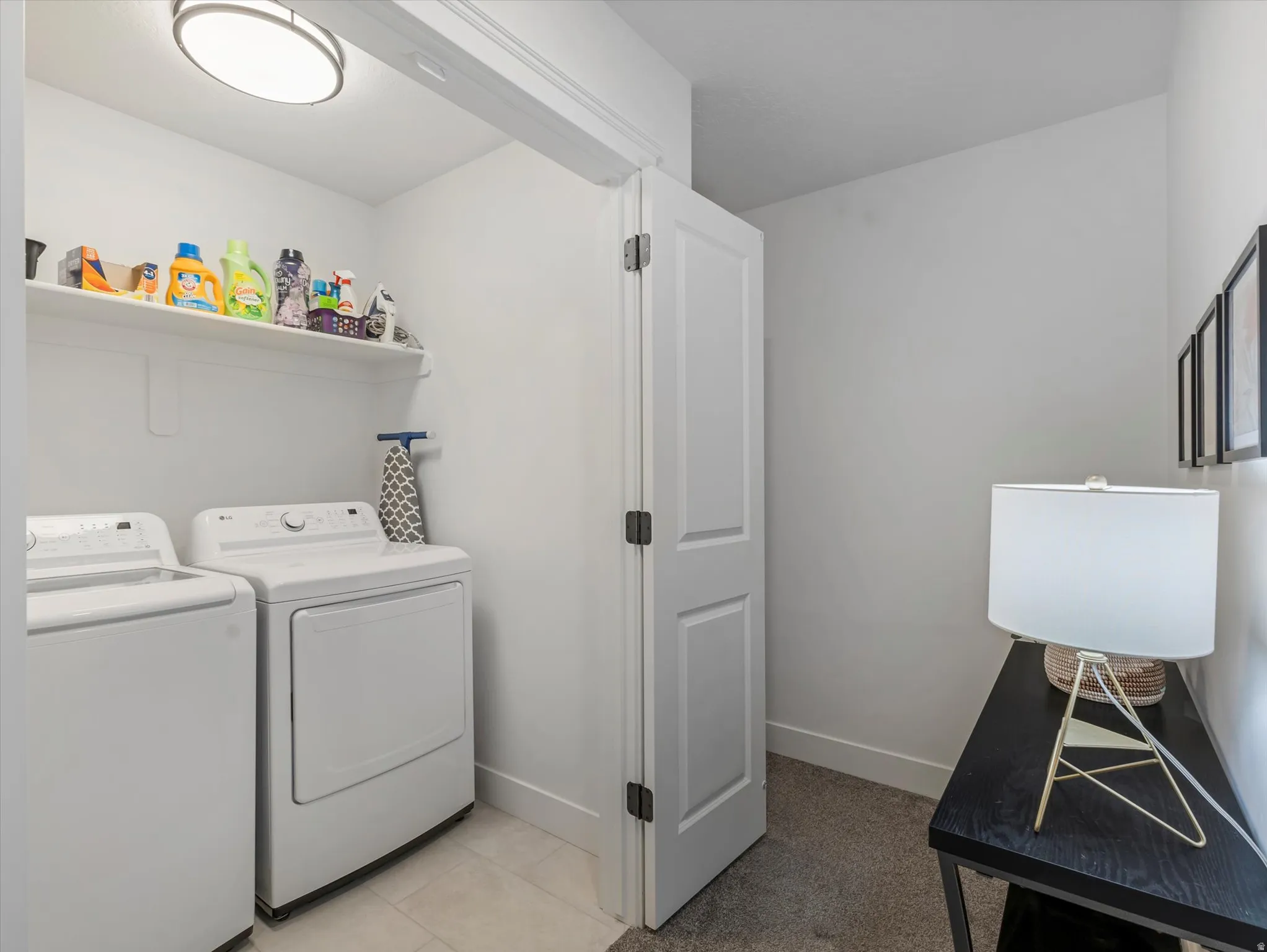 Laundry area with baseboards and washer and clothes dryer