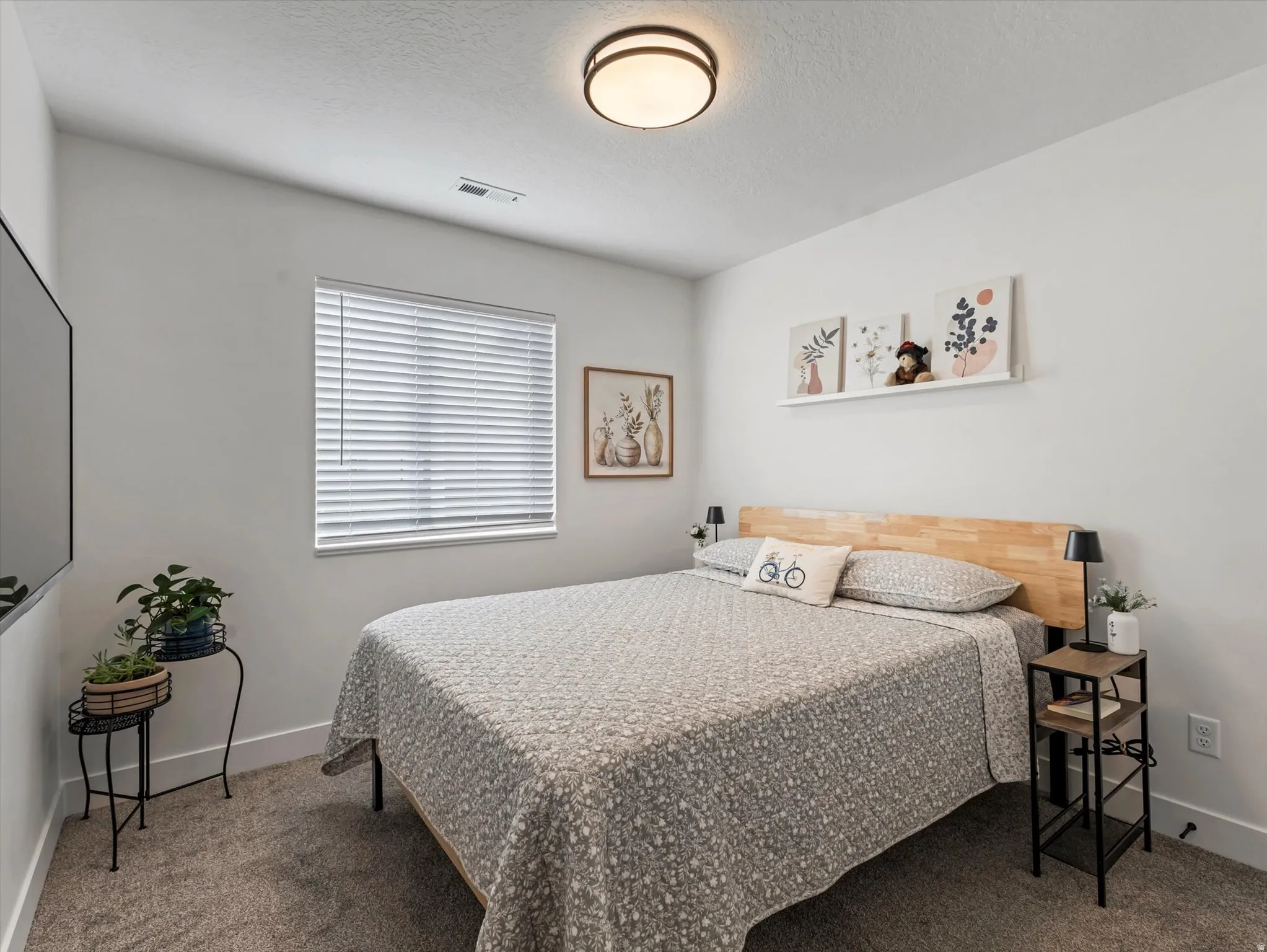 Bedroom featuring carpet floors and a textured ceiling