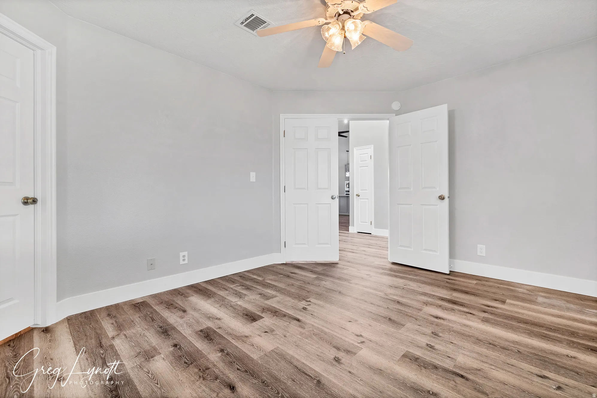 Unfurnished bedroom with light wood finished floors and a ceiling fan