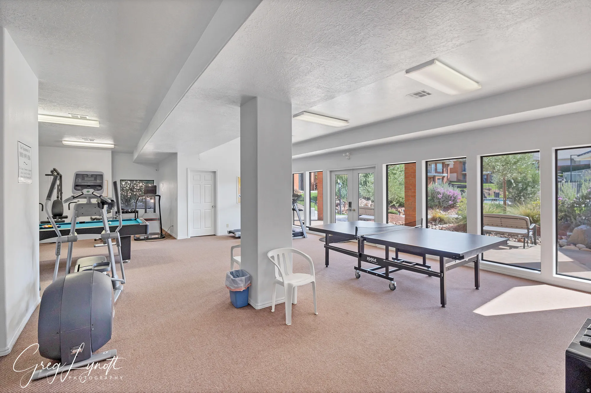 Recreation room featuring a textured ceiling and french doors