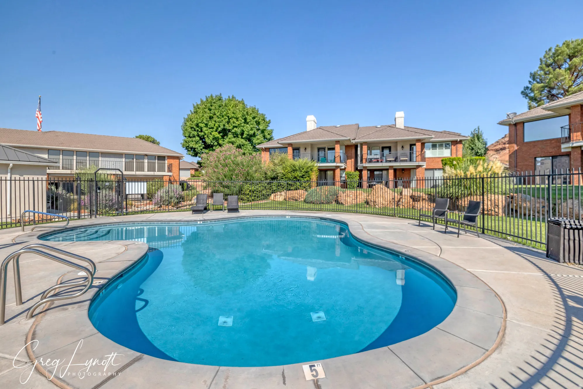 Community pool featuring a patio area and a residential view