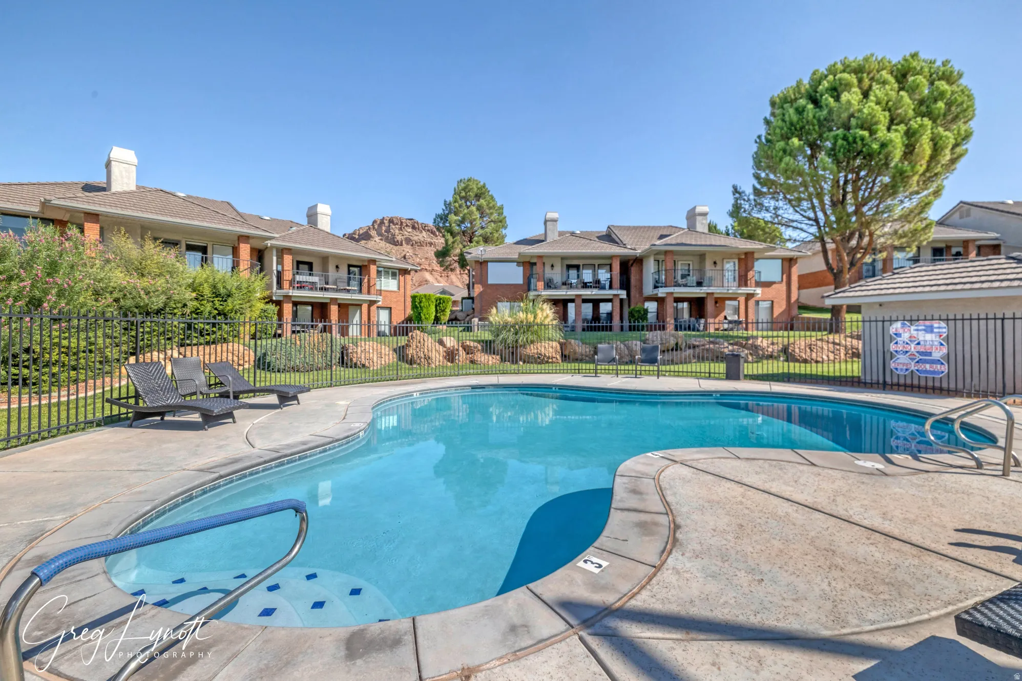 Community pool featuring a patio area and a residential view