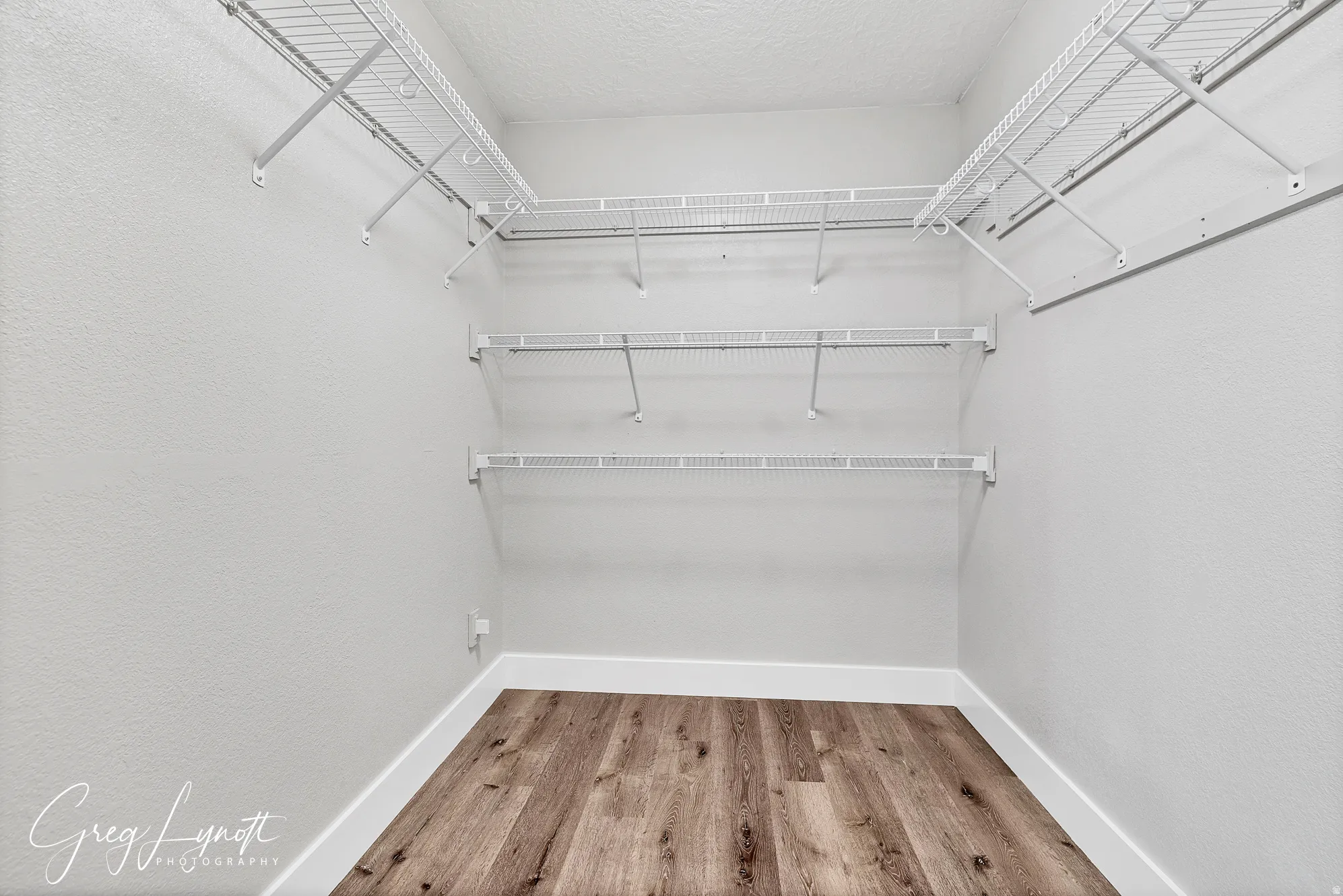 Walk in closet featuring light wood finished floors