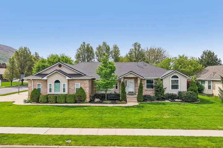 Single story home featuring brick siding, a front yard, and a shingled roof