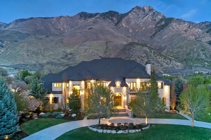 French country inspired facade with a front yard, a chimney, and a mountain view