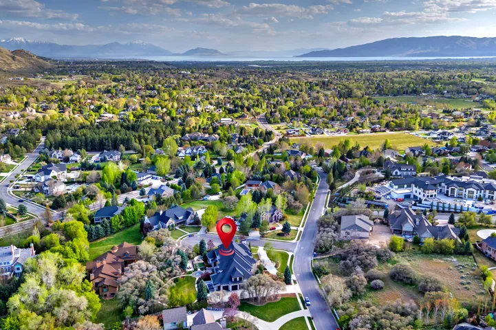 View of property location with a mountain backdrop and nearby suburban area