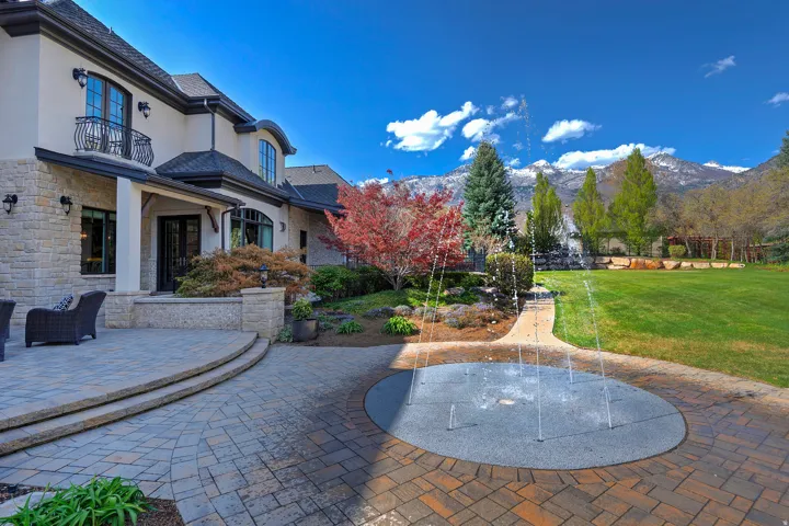 Patio / terrace featuring a lawn, a patio, and a mountain view