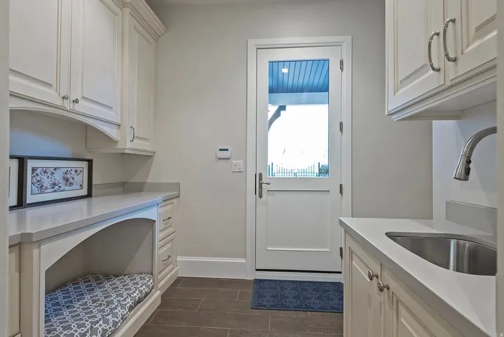 Laundry room featuring a sink and baseboards