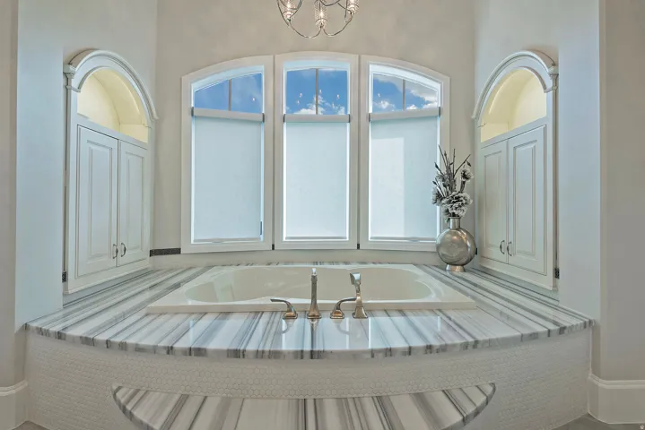 Full bathroom featuring a bath and suspended lighting