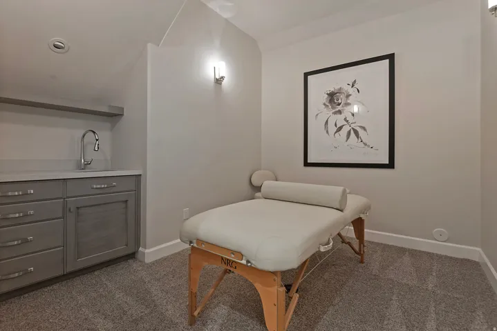 Living area featuring light carpet and baseboards