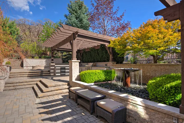 View of patio with an outdoor kitchen and a pergola