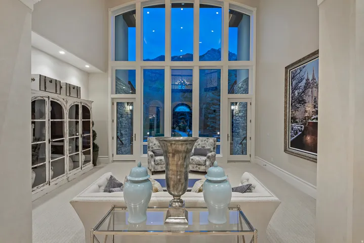 Living room with a high ceiling, carpet, and recessed lighting