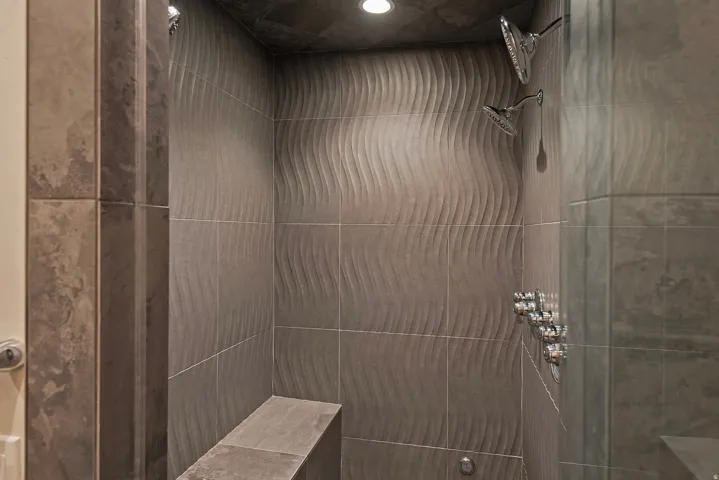 Bathroom with tiled shower and recessed lighting