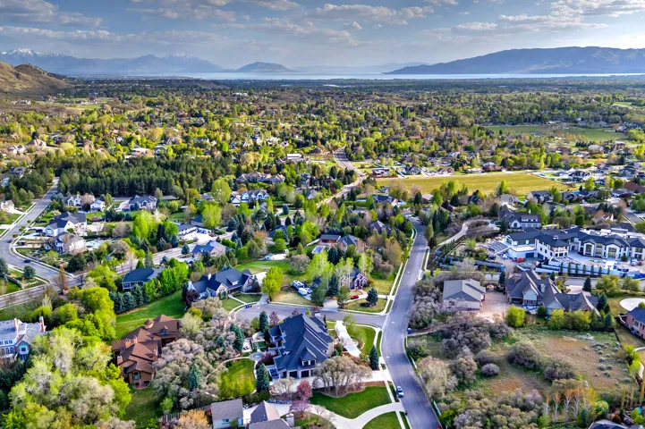 Aerial overview of property's location with mountains and nearby suburban area